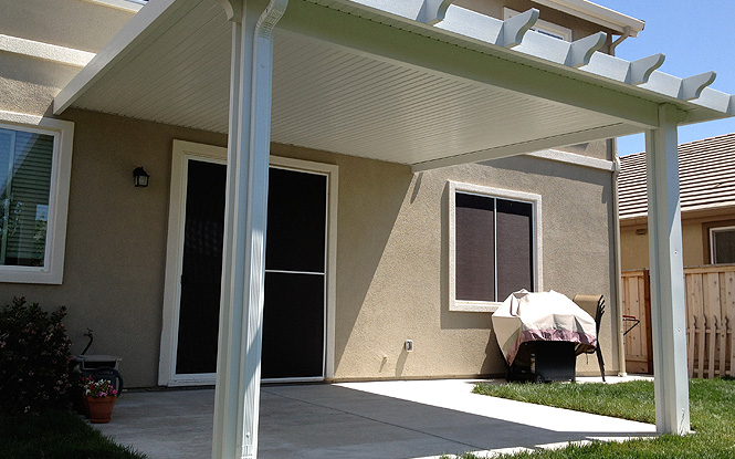 Relaxing retreat under a blooming pergola, surrounded by lush greenery.