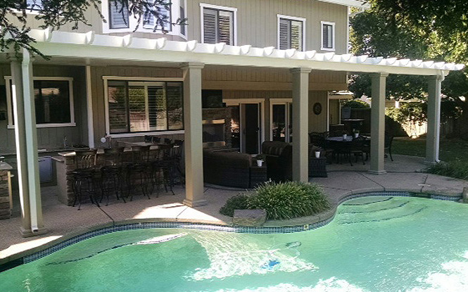 Relaxing retreat: A shaded patio with a pergola and ceiling fan.