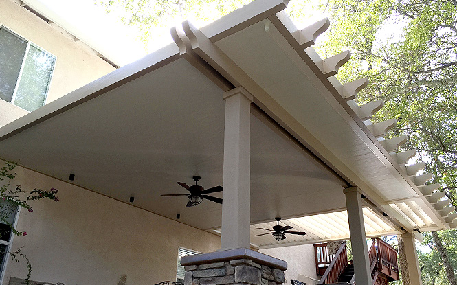 Relaxing retreat: A shaded patio with a pergola and ceiling fan.
