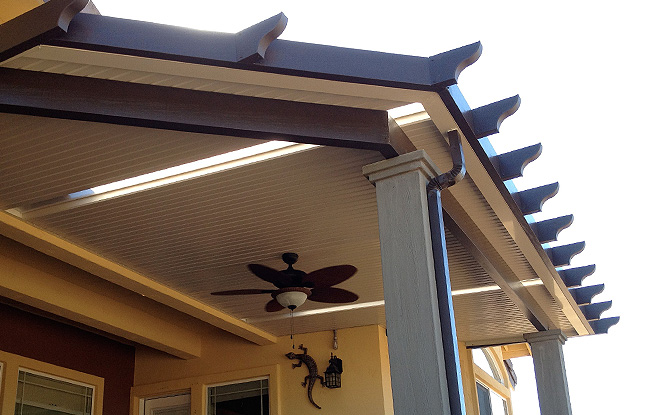 A cozy covered patio features a wooden ceiling fan for comfort.